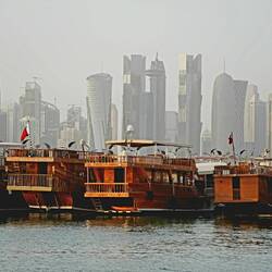 Moderne Skyline trifft auf traditionelle Dau-Boote