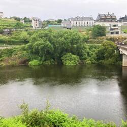 Pilgrim March over the bridge in the rain saying adios to PORTOMARÍN