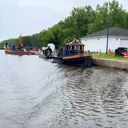Canal authority work equipment and dredge pipes at Lock 20
