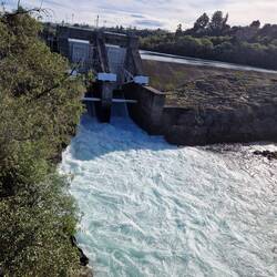 The dam once opened gushes with water