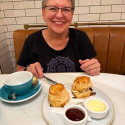 Janet getting ready to enjoy scones with clotted cream and jam