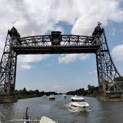 Our flotilla follows beneath a liftbridge