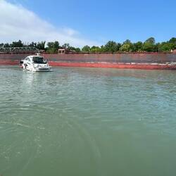 The freighter appears; our flotilla heads for Lock No. 1