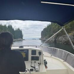 Janet (Ramble On) on the helm leaving Gorge Harbour