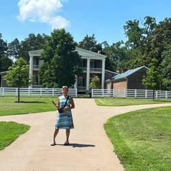 Tracy with mansion in background