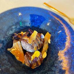 Mochi chocolate doughnut with banana filing, peanut brittle and fudge sauce