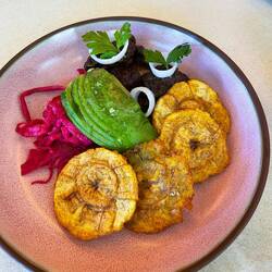 Pork with plantain, pickled cabbage, onions and avocado