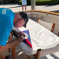The 'Signing The Burgee' ceremony. Apologies to Nina for cutting her in half.