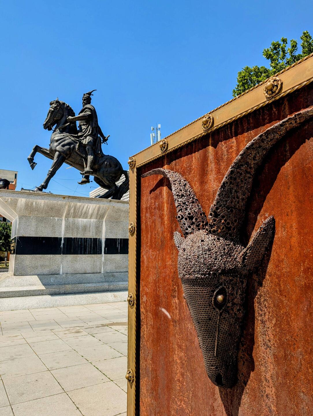 Statue of Gjergj Kastrioti Skanderbeg and a helm fitting art Installation