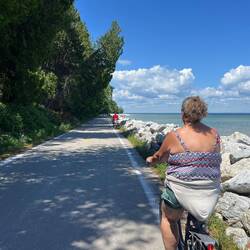 Rosanne riding her bike around the island. This is on the east side near Mission Point.