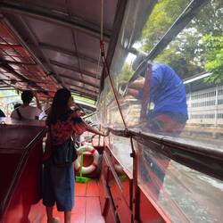 The conductor on the klong taxi that plies Klong Saen Saep.