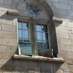 Behive on the window sill in the town