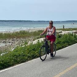 Rosanne riding her bike on the Mackinac Island highway. (No cars allowed.)