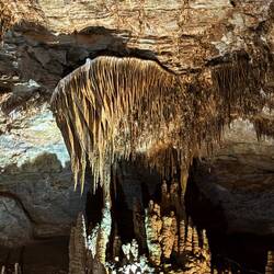 The big stalactite is held on the ceiling by the right side only