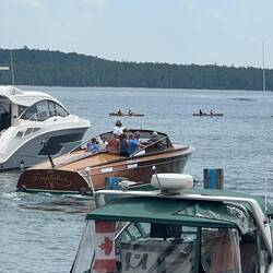 This beautiful wood boat came through the marina today. Group of kayakers going by as well.