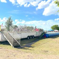 Dog swims with mouth full. Climbs out. Races up the steps to do it again! 2 go's.