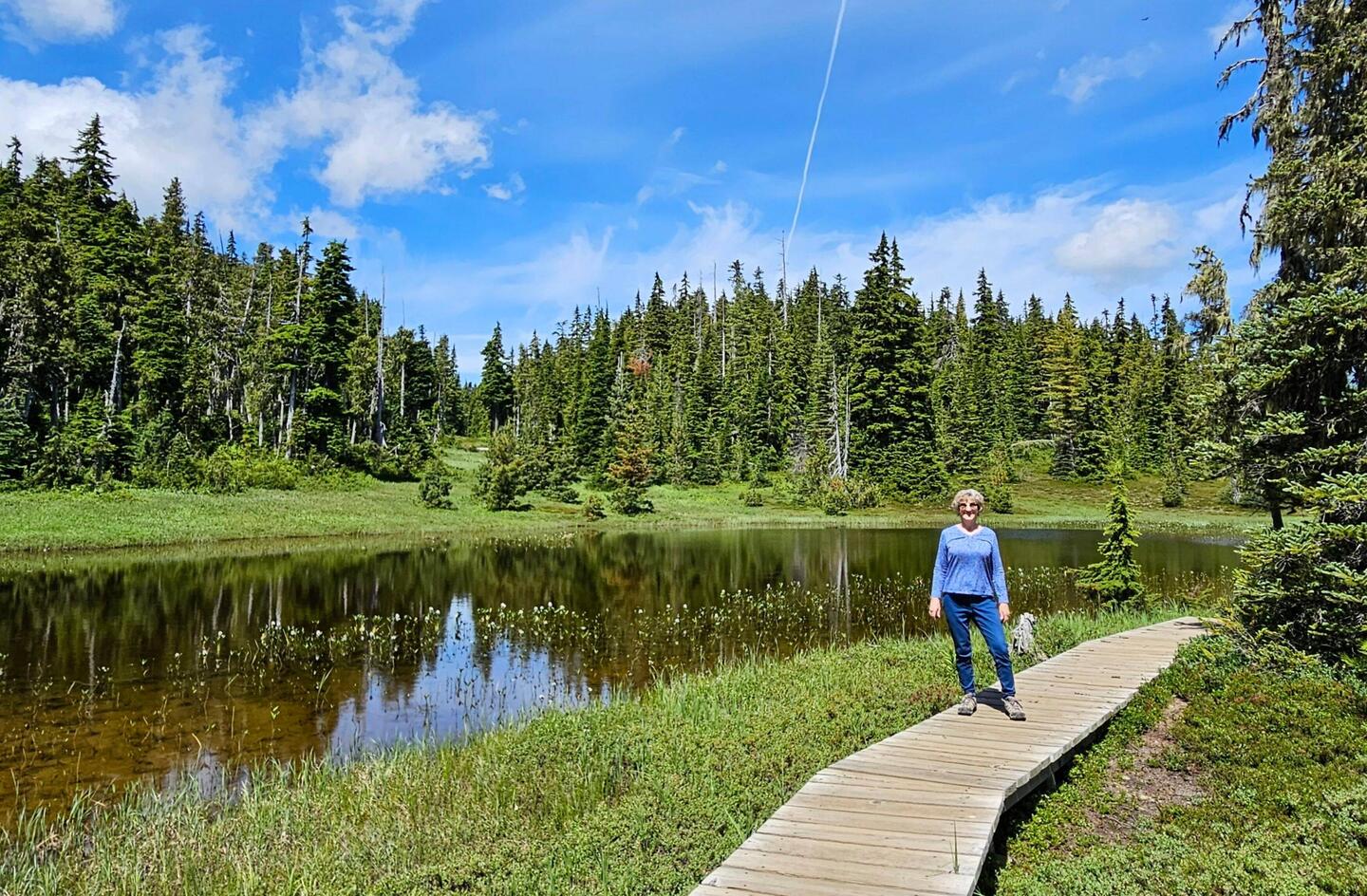 Me on boardwalk next to a pond on Paradise Meadow Trail