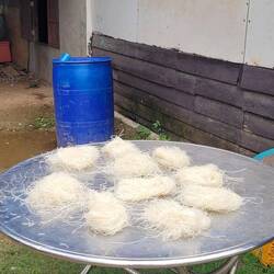 Homemade rice noodles drying in the sun.