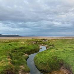 Water flowing into the sand on the edge of the coast