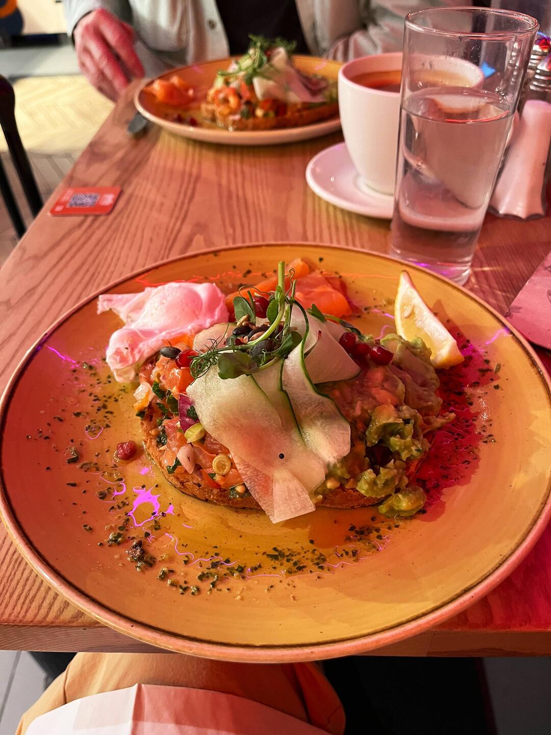 Brekkie at Heathrow -- a hat the Brits call smashed avocado, with poached egg and smoked salmon. De