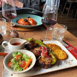 Fabulous roast pork pieces with pomegranate sauce, salad, and potatoes. Armenia is high on our tra!