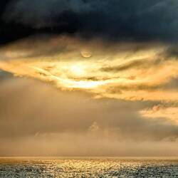 Midnight sun behind the clouds