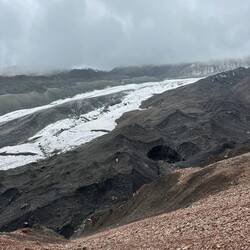 Man beachte, dass unter der schwarzen Gesteinsschicht der Gletscher befindet.