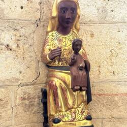Dark-toned wooden sculpture of La Virgen