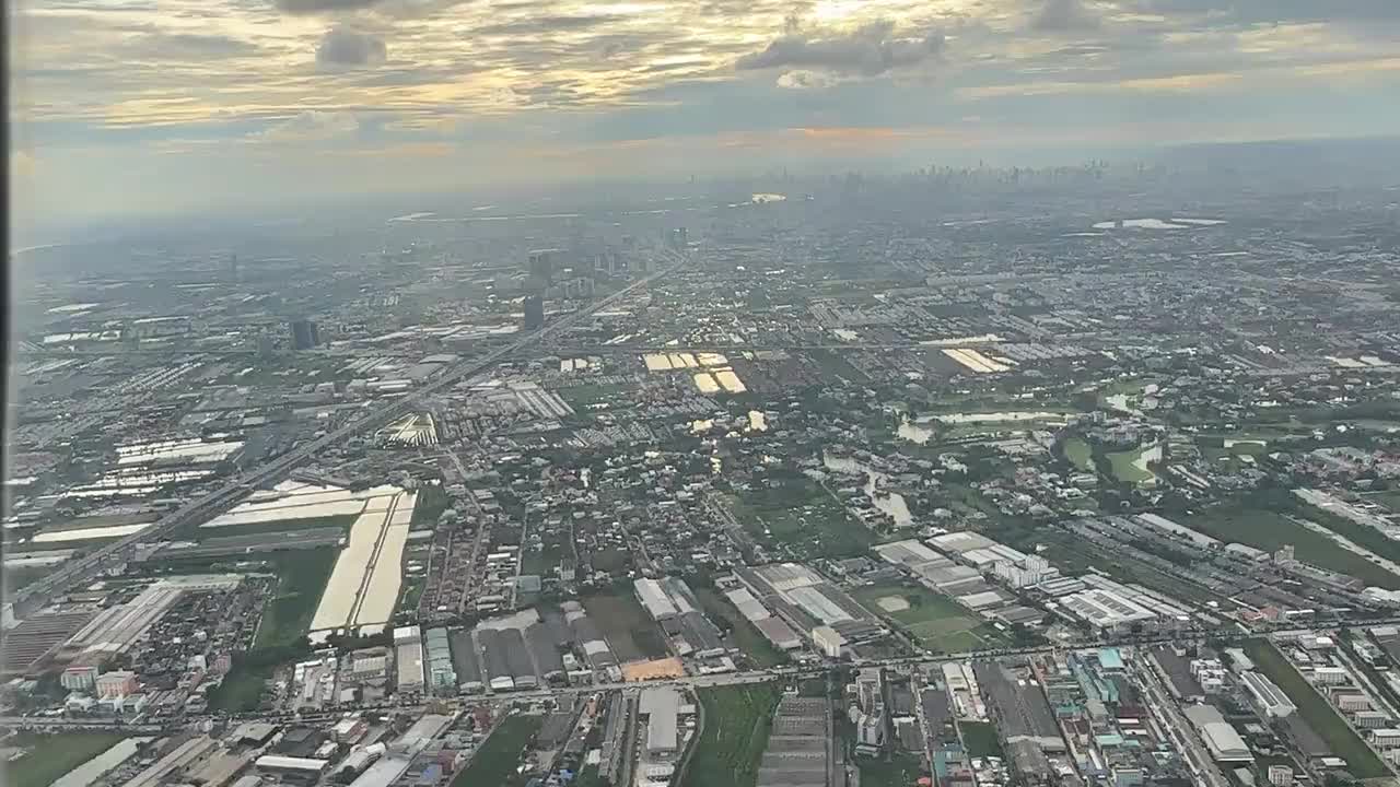 MH783 climbing over Samut Prakan after takeoff, with Bangkok in the distance.