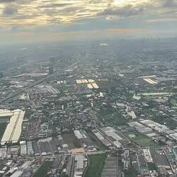 MH783 climbing over Samut Prakan after takeoff, with Bangkok in the distance.
