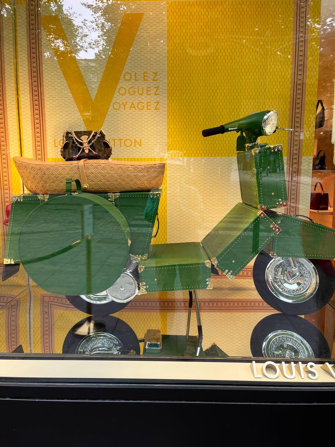 Louis Vuitton shop window with motor scooter made of suitcases.