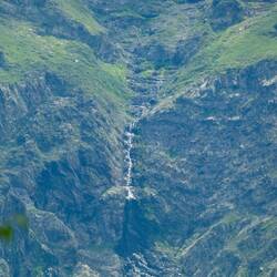 A waterfall high on the opposite side of the valley