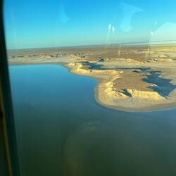 The contrast between water and desert.