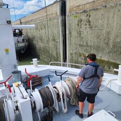The crew member, Eddy, surveying the rope at the front of the ship