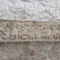 A bas-relief outside our risto window depicting one of the early five-year song and dance festivals.