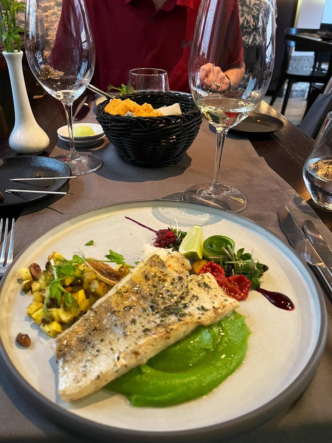 Pan fried perch on a bed of puréed peas with a salsa of mango and pistachios