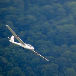 Several gliders were wheeling around the sky below the clouds