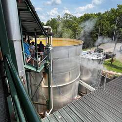 Stills out in the open, notice the steam from the fermentation