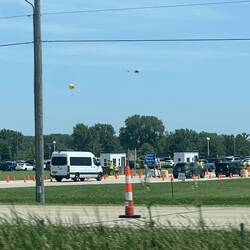 Looks like a hot air baloon and helicopter over Wittman Field.