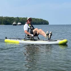 On my kayak. The closest blue boat behind me, was also at Mackinac Island while we were there.
