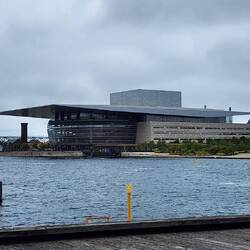 The opera house with the power plant to the right. They burn refuse for power