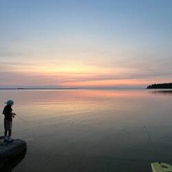 Some kids fishing at the Tennison Bay kayak launch, in the sunset