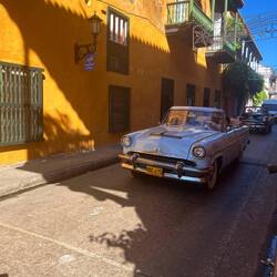 Tourists travelling in antique cars