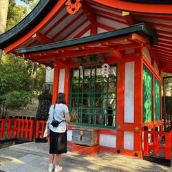 Lexi asking for a blessing at a shrine of a majestic horse
