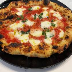Margherita pizza. Instead of sauce used grated tomato