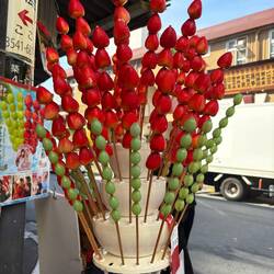 Japanese love strawberries! This strawberry/grape on a stick was common at markets