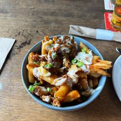 Poutine. Hot chips, cheese curd with gravy and meats