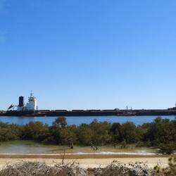 Loaded ship departing Port - see how much lower it sits in the water