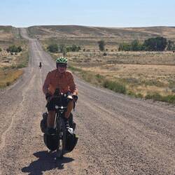 Chris climbing dirt road incline.