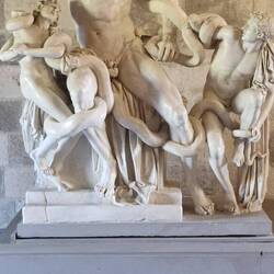 Zeus with his children being attacked by snakes to prevent him from protecting the city